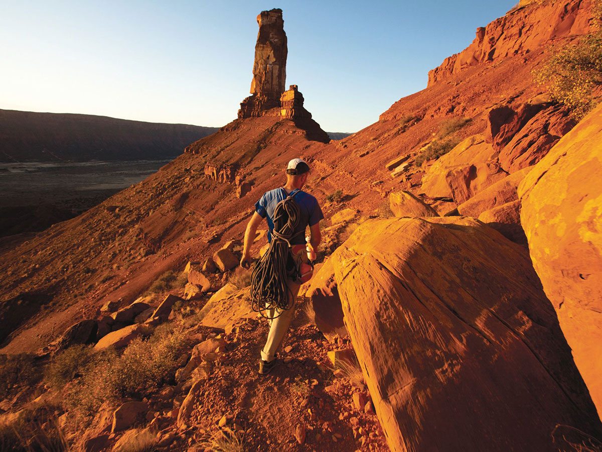 Man climbing a mountain in the desert