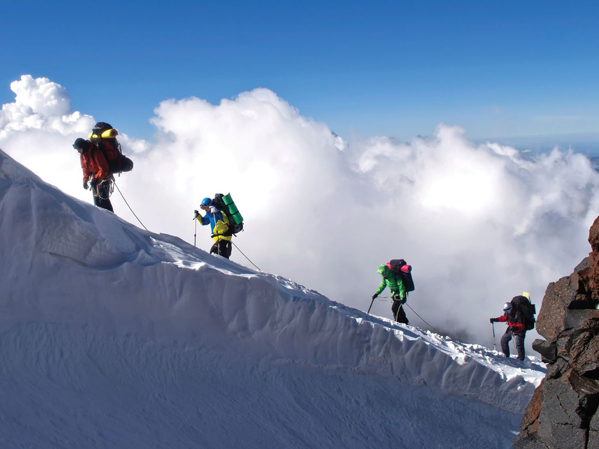 Group of hikers climbing a snowy mountain
