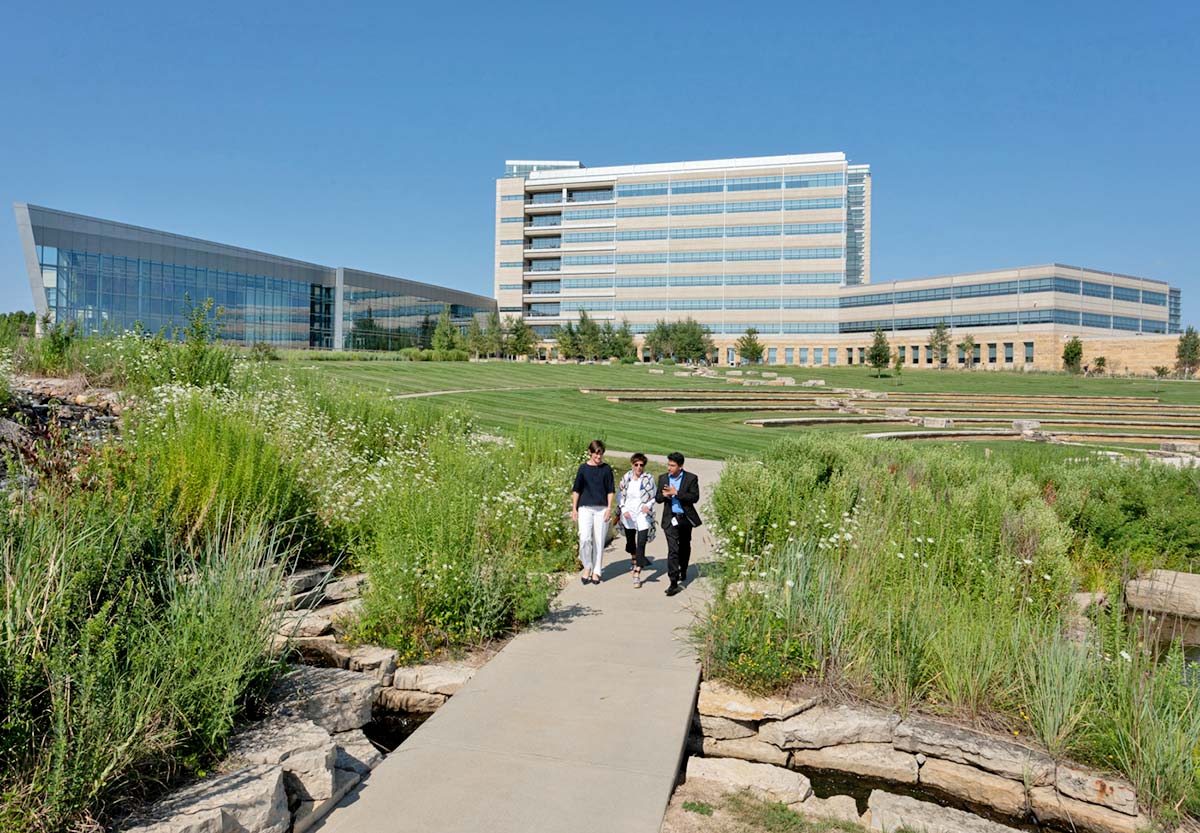 Employees walk through the West Des Moines office backyard