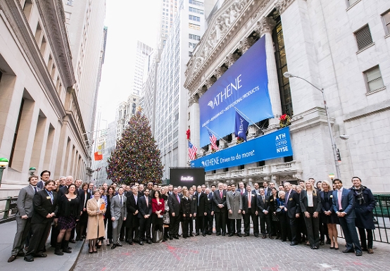 Athene Holding team posing in front of The New York Stock Exchange on listing day of Athene's IPO