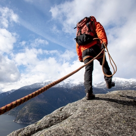 Mountain climber carrying rope